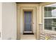 Covered entryway featuring a stylish front door with stone accents and decorative columns at 9478 Sw 52Nd Loop, Ocala, FL 34481