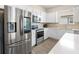 Modern kitchen featuring stainless steel appliances, white cabinets, and quartz countertops at 9478 Sw 52Nd Loop, Ocala, FL 34481