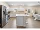Modern kitchen with white cabinets, stainless steel appliances, and an island at 9478 Sw 52Nd Loop, Ocala, FL 34481
