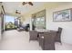 Relaxing screened lanai with ceiling fans, dining area, and a view of the well-maintained backyard at 9478 Sw 52Nd Loop, Ocala, FL 34481