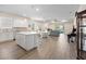 Open concept living space with a modern kitchen, dining area, and wood floors at 9478 Sw 52Nd Loop, Ocala, FL 34481