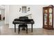 Formal living area featuring a grand piano, a grandfather clock, and modern flooring at 9478 Sw 52Nd Loop, Ocala, FL 34481