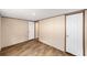 A simple bedroom has wood-look floors and white doors at 221 Se 167Th Ct, Silver Springs, FL 34488