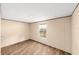A neutral bedroom includes wood-look flooring and a bright window at 221 Se 167Th Ct, Silver Springs, FL 34488