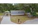 Home featuring neutral siding, a carport, and a well-maintained yard with mature trees and landscaping at 221 Se 167Th Ct, Silver Springs, FL 34488