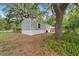 Charming single-story home featuring neutral siding, surrounded by mature trees and a lush, natural landscape at 221 Se 167Th Ct, Silver Springs, FL 34488