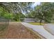 Single Gathering home with a carport, green grass, trees and a long driveway at 221 Se 167Th Ct, Silver Springs, FL 34488