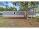 Charming single-story home featuring gray siding, a wooden entry staircase, and a well-kept front yard at 221 Se 167Th Ct, Silver Springs, FL 34488