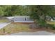 Charming home with neutral siding, a carport, and a well-kept yard featuring mature trees and landscaping at 221 Se 167Th Ct, Silver Springs, FL 34488