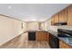 Open kitchen with black appliances and marble countertops, seamlessly connecting to the dining and living areas at 221 Se 167Th Ct, Silver Springs, FL 34488