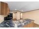 Open kitchen with black appliances and marble countertops, seamlessly connecting to the living area at 221 Se 167Th Ct, Silver Springs, FL 34488