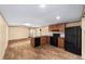 Bright kitchen featuring modern appliances, wood cabinets, and wood-look flooring, creating a welcoming space at 221 Se 167Th Ct, Silver Springs, FL 34488