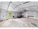 Interior of outbuilding with concrete floor, lighting, and ample workspace with tools and equipment at 221 Se 167Th Ct, Silver Springs, FL 34488
