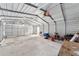 Bright outbuilding interior with concrete floors, fluorescent lighting, and open workspace for projects at 221 Se 167Th Ct, Silver Springs, FL 34488