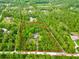 Aerial view of secluded property featuring mature trees and a cozy home, outlined in red at 3682 Jack Pine Ln, Ormond Beach, FL 32174