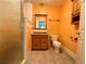 Bathroom with orange walls, tiled floors, and a shower at 3682 Jack Pine Ln, Ormond Beach, FL 32174