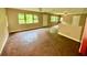 Large living room featuring multiple windows, offering ample natural light and renovation possibilities at 3682 Jack Pine Ln, Ormond Beach, FL 32174