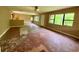 Spacious living room with hardwood floors, multiple windows offering great natural light, ready for renovation at 3682 Jack Pine Ln, Ormond Beach, FL 32174
