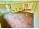 Open-concept living room with hardwood floors, neutral paint, and multiple entry points at 3682 Jack Pine Ln, Ormond Beach, FL 32174
