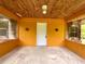 Enclosed porch with wood paneling and concrete floor, offering a bright and inviting space at 3682 Jack Pine Ln, Ormond Beach, FL 32174