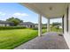 Covered patio with brick flooring, overlooking a well-maintained lawn and picturesque backyard at 3940 Se 5Th Ave, Ocala, FL 34480