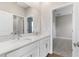 Bathroom featuring double vanity, marble countertop, and a modern interior door at 3940 Se 5Th Ave, Ocala, FL 34480