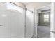 Modern bathroom showcasing a glass-enclosed shower with white tile and a view into the bedroom at 3940 Se 5Th Ave, Ocala, FL 34480