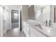 Elegant bathroom featuring a double vanity with quartz countertop, modern fixtures, and tiled floors at 3940 Se 5Th Ave, Ocala, FL 34480