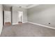 Spacious bedroom with neutral walls, plush carpeting, and open doorway to bathroom, providing a welcoming feel at 3940 Se 5Th Ave, Ocala, FL 34480