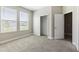 Cozy bedroom with natural light, a closet, and plush carpeting for comfort at 3940 Se 5Th Ave, Ocala, FL 34480