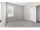 Comfortable bedroom with carpet, window and neutral walls that offers a relaxing space at 3940 Se 5Th Ave, Ocala, FL 34480