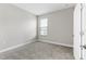 Bedroom with neutral walls, plush carpeting, and a window that provides natural lighting at 3940 Se 5Th Ave, Ocala, FL 34480