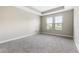 Bright bedroom featuring neutral walls, plush carpeting, and a pair of windows providing ample natural light at 3940 Se 5Th Ave, Ocala, FL 34480