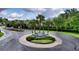 Community entrance with palm trees, shrubbery and a stylish 'The Village' sign at 3940 Se 5Th Ave, Ocala, FL 34480