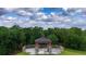 Close-up aerial shot of a gazebo with stone pillars and wooden deck on top of a grassy knoll at 3940 Se 5Th Ave, Ocala, FL 34480