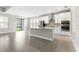 Open-concept kitchen seamlessly flows into the living area, featuring stainless steel appliances and an island at 3940 Se 5Th Ave, Ocala, FL 34480