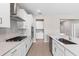 Modern kitchen featuring an island, stainless steel appliances, and sleek white cabinetry with countertop at 3940 Se 5Th Ave, Ocala, FL 34480