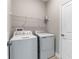 Functional laundry room featuring a washer, dryer, and shelving, ideal for laundry day at 3940 Se 5Th Ave, Ocala, FL 34480