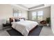Inviting main bedroom with a tray ceiling, natural light, and stylish decor, creating a relaxing retreat at 3940 Se 5Th Ave, Ocala, FL 34480