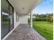 Charming patio with brick flooring and a welcoming entrance mat leads to the home's interior through large sliding glass doors at 3940 Se 5Th Ave, Ocala, FL 34480