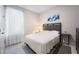 Cozy bedroom featuring a queen bed, window with white curtains, and neutral decor at 1192 Via Galuppi St, Kissimmee, FL 34759