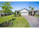 Charming home featuring a well manicured lawn, brick paved driveway, and palm trees at 1192 Via Galuppi St, Kissimmee, FL 34759