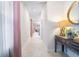 Bright hallway with decorative table, mirror, and views into other rooms at 1192 Via Galuppi St, Kissimmee, FL 34759