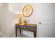 Hallway table with decoratives, including a lamp and decorative plants, with a decorative mirror at 1192 Via Galuppi St, Kissimmee, FL 34759