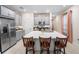 Spacious kitchen featuring a large island with seating, stainless steel appliances, and modern cabinetry at 1192 Via Galuppi St, Kissimmee, FL 34759