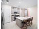 Stylish kitchen features stainless appliances, gray cabinets, and a white countertop island with bar stool seating at 1192 Via Galuppi St, Kissimmee, FL 34759