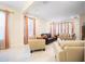 Comfortable living room with tile floors, large windows, and neutral-toned furniture at 1192 Via Galuppi St, Kissimmee, FL 34759