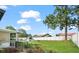 Spacious backyard with a white privacy fence, mature trees, and an above-ground pool at 24 Sapphire Way, Ocala, FL 34472