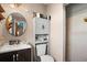 Functional bathroom featuring a toilet, cabinet, sink with dark vanity, and a standing shower at 24 Sapphire Way, Ocala, FL 34472