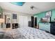 Comfortable bedroom features dark laminate floors, a ceiling fan, and direct access to the bathroom at 24 Sapphire Way, Ocala, FL 34472